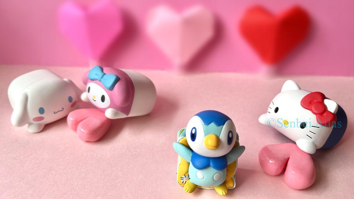 Valentine's Day in Japan: A festive group photo featuring Pokémon Piplup (ポッチャマ), Hello Kitty (ハローキティ), Cinnamoroll (シナモロール), and My Melody (マイメロディ) surrounded by colorful hearts.
