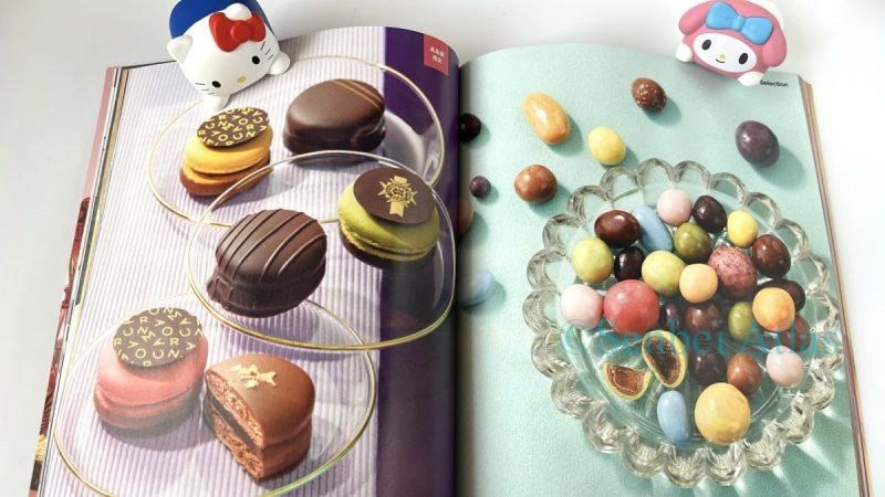 A double-page spread from Takashimaya's Valentine's Day event booklet. The left page shows Le Cordon Bleu macarons (ル・コルドン・ブルーのマカロン), and the right page shows François DOUCET chocolates (フランソワ・デュセのチョコ). Hello Kitty and My Melody (ハローキティとマイメロディ) peek out from each colorful page.