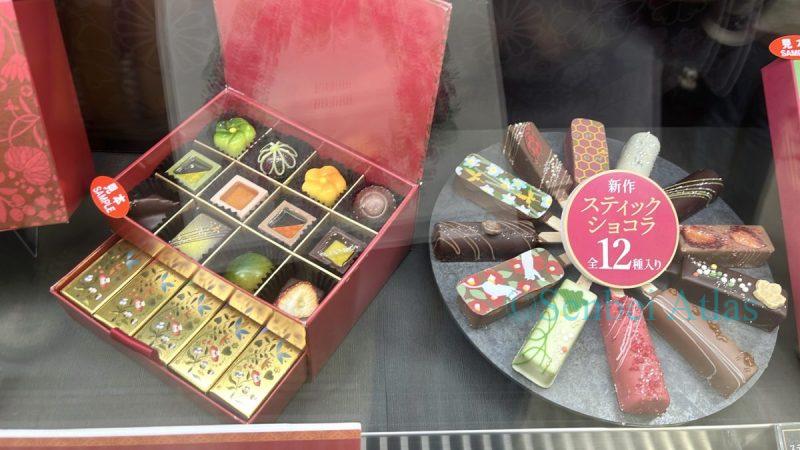 BEL AMER (ベルアメール) chocolates, featuring colorful 'Stick Chocolat' (スティックショコラ) and boxed chocolates shaped like traditional Japanese balls and flowers, creating a beautiful Japanese-style atmosphere.