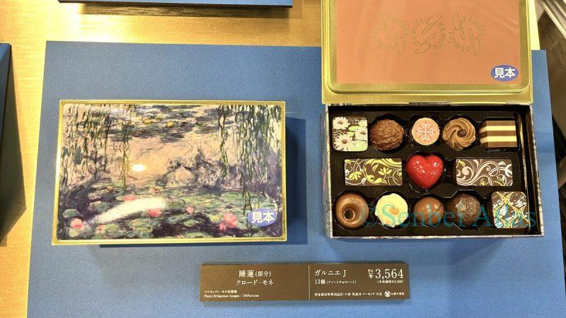 Garnier (ガルニエ) chocolates in a gift tin featuring Monet's 'Water Lilies' (モネの『睡蓮』). The design showcases the Impressionist painting on a metal container, sold at the Takashimaya Valentine's Day event.