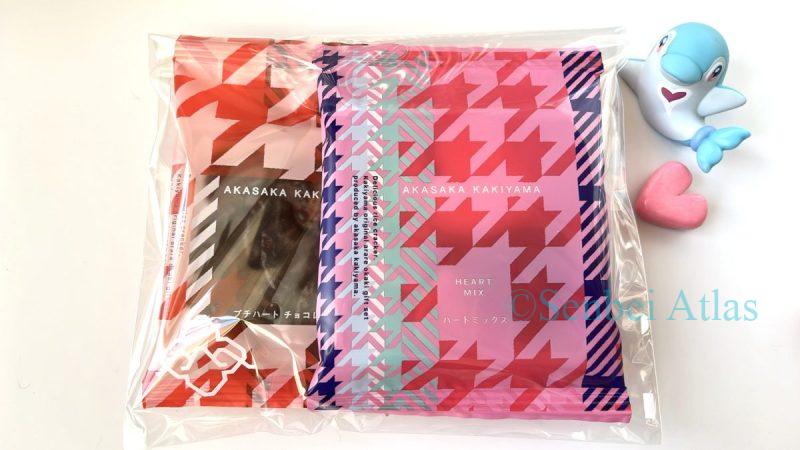 Akasaka Kakiyama "Heart Mix" and "Petit Heart" (柿山のハートミックスとプチハート) packed in a transparent bag, with a Palafin (Irukaman) figure on the side.