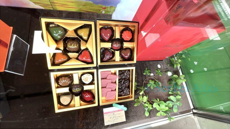 Pierre Ledent (ピエール・ルドン) chocolates in a gift box. The colorful, glossy chocolates are arranged beautifully, creating a luxurious and elegant atmosphere.