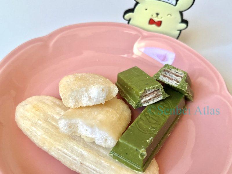A cross-section of Matcha KitKat and Happy Turn lies on a plate, with Pompompurin behind it.
