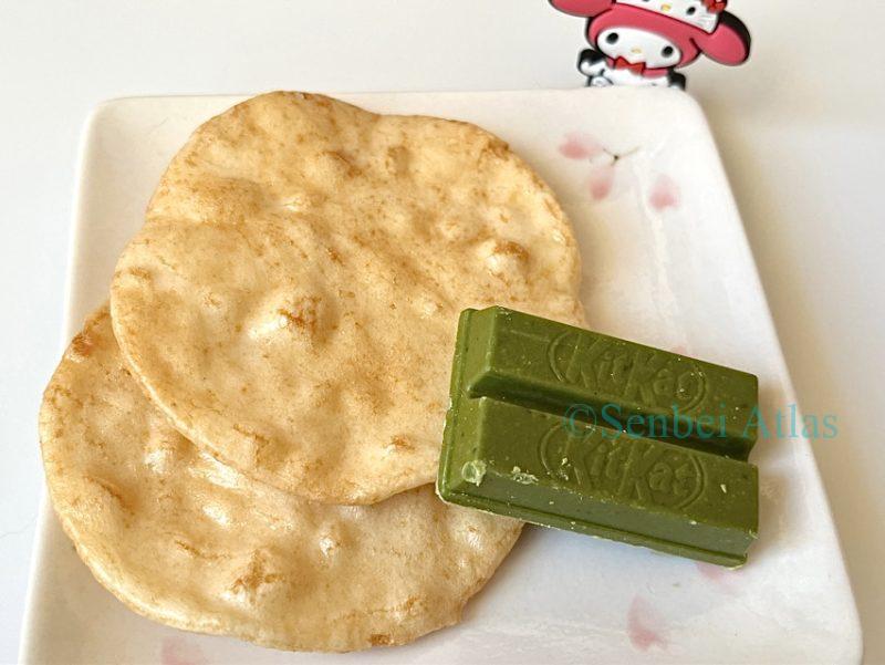 Matcha KitKat and Magari senbei Senbei (Japanese rice crackers) sit on a plate, with My Melody them.