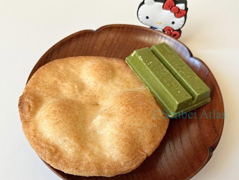 Matcha KitKat and Teshioya sit on a plate, with Kitty behind them.