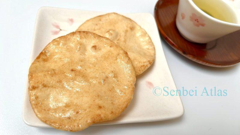 Traditional Japanese tea time: Senbei (Japanese rice crackers) and Green tea served in cherry blossom (Sakura) patterned dishes