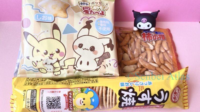 Packages of three senbei (Kaki-no-Tane (柿の種), Petit Usuyaki (プチうす焼), Chiisana Hoshi Tabeyo (小さな星たべよ)) with a Kuromi (クロミ) Figure.