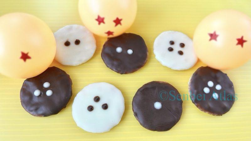 Chocolate senbei (せんべい) inspired by Dragon Ball (ドラゴンボール) lined up with three Dragon Balls in the background.
