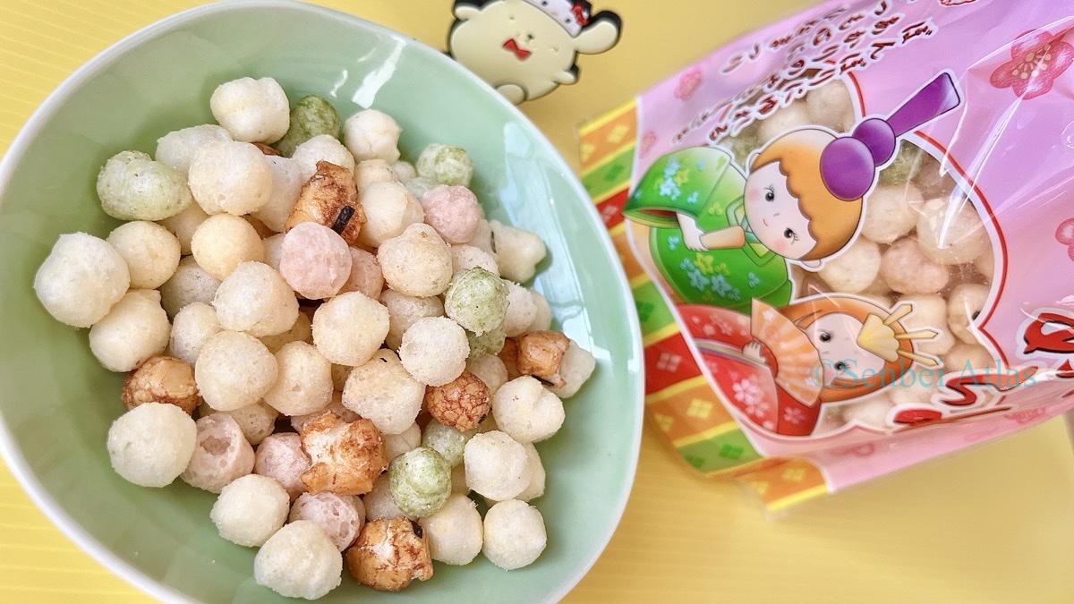 Colorful Japan's savory umami rice snacks on a plate with the Echigo Seika (越後製菓) Hina Arare (ひなあられ) package and Pompompurin (ポムポムプリン).