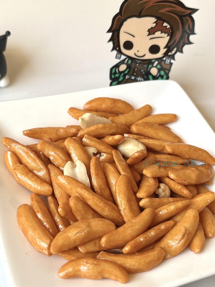 Kaki-no-Tane (柿の種) and peanuts on a Plate with a Tanjiro Kamado (竈門炭治郎) figure in the background.