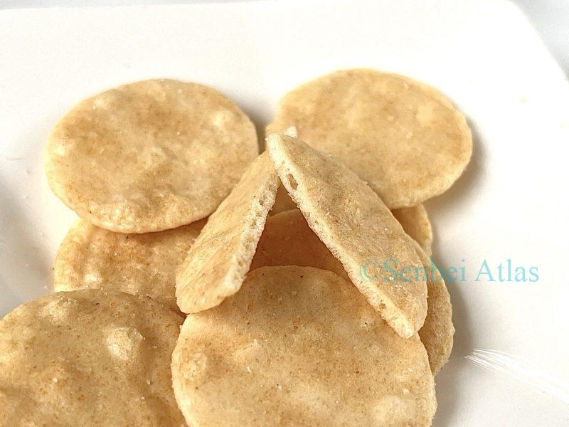 A close-up cross-section of a Petit Usuyaki cracker, showing how thin and crispy it is