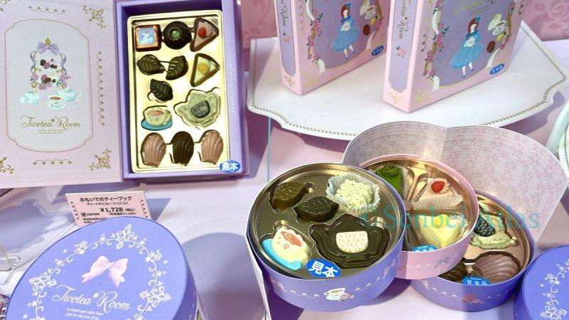 Miniature chocolates from Twotea Room (トゥーティールーム) in the shapes of teapots and cakes, presented in circular and book-shaped packaging.