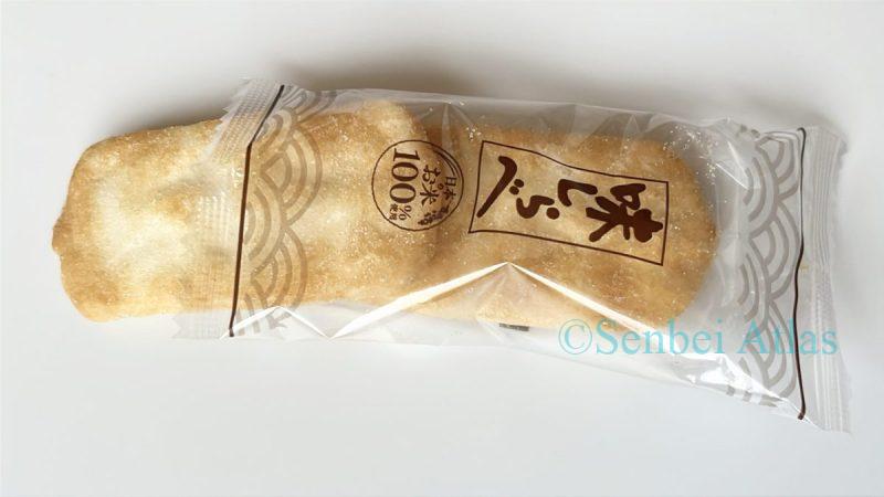 A single Ajishirabe (味しらべ) cracker peeking halfway out from the top of its individual wrapper.