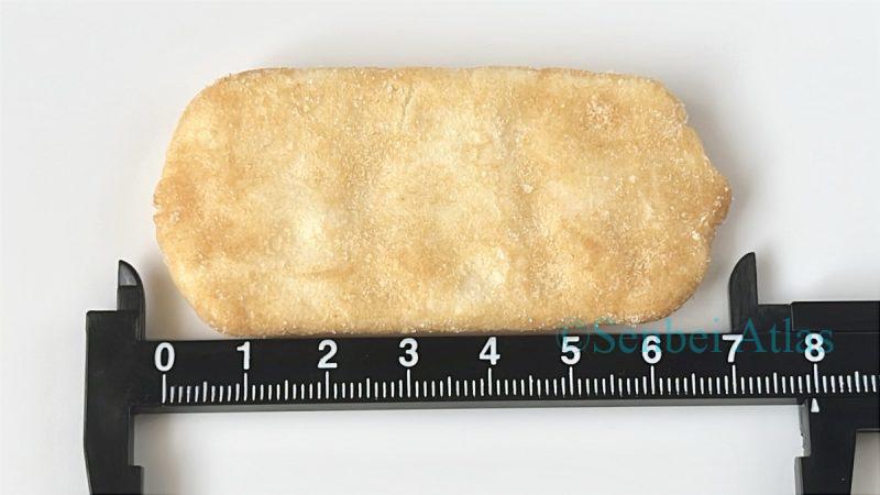 Measuring the size of an Ajishirabe (味しらべ) cracker with a ruler.