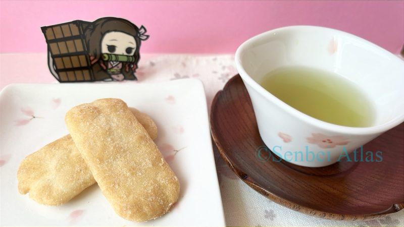 Ajishirabe (味しらべ) on a cherry blossom pattern plate served with green tea and a Nezuko (禰󠄀豆子) sticker in the background.