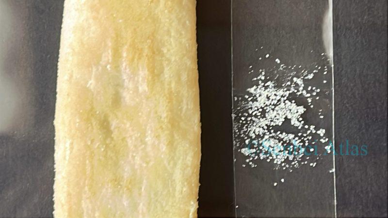 Close-up of Happy Turn (ハッピーターン) and its "Magic Powder" collected on cellophane tape.