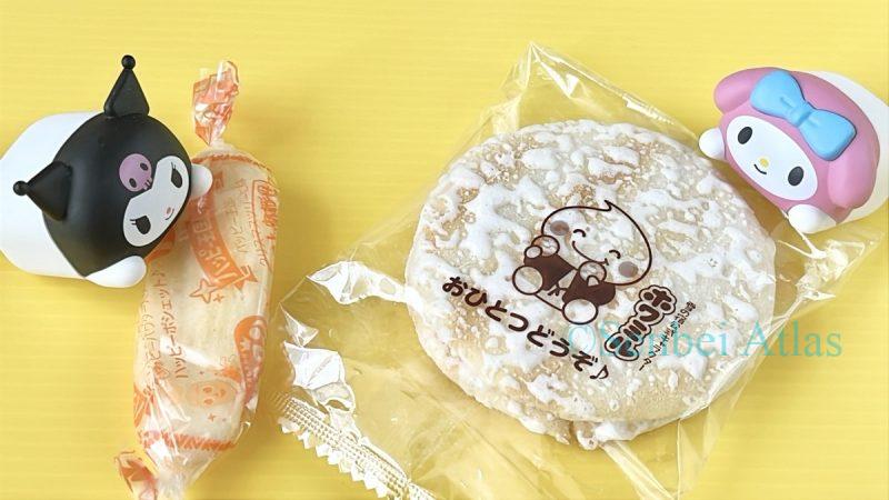 Kuromi (クロミ) and My Melody (マイメロディ) figures sharing senbei with each other.