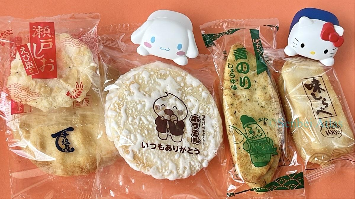 Various senbei individual wrappers with Hello Kitty (ハローキティ) and Cinnamoroll (シナモロール) figures.