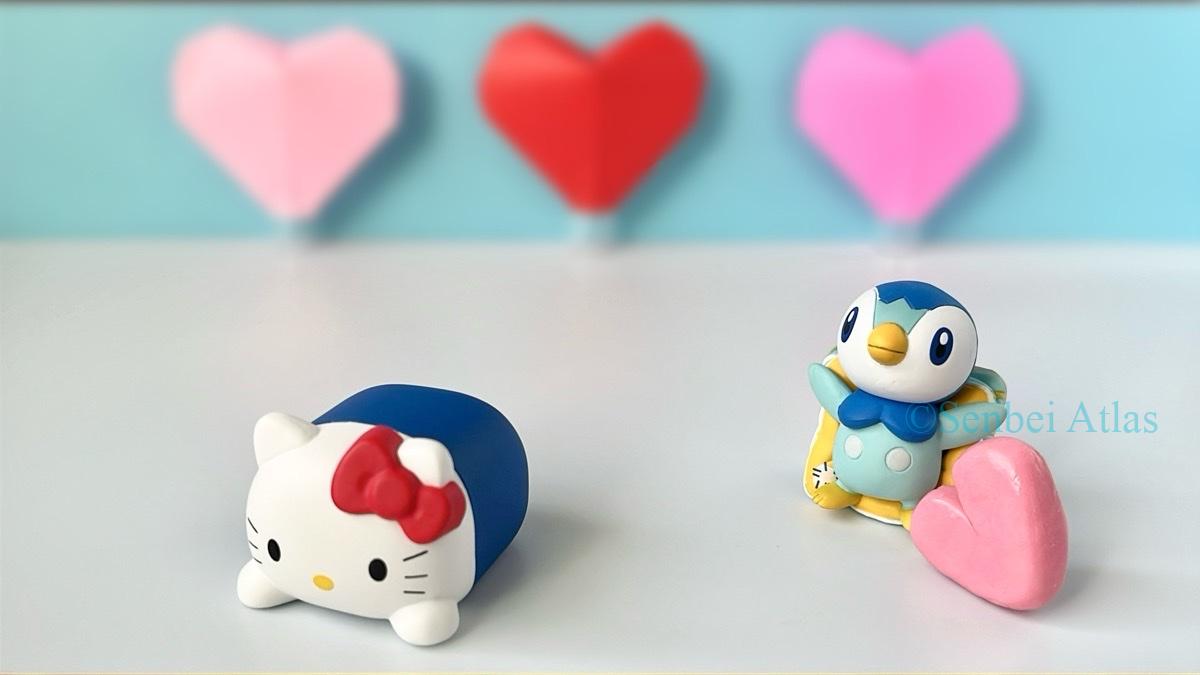 A White Day (ホワイトデー) themed photo of a Piplup (ポッチャマ) figure giving one heart to a Hello Kitty (ハローキティ) figure.