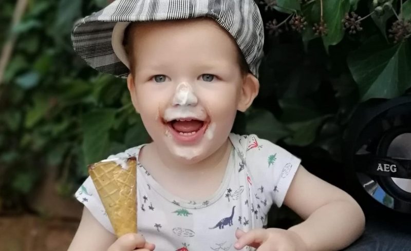 A child with ice cream around their mouth.