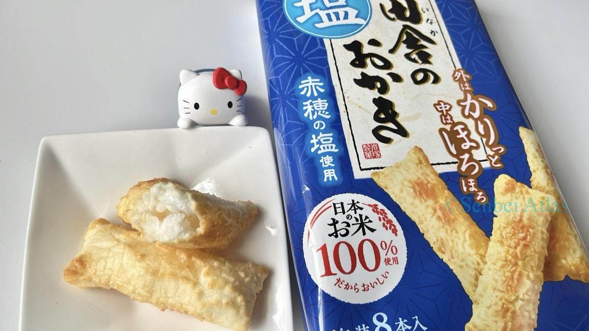Inaka no Okaki (田舎のおかき) package and contents with a Hello Kitty (キティ) figure in the background.