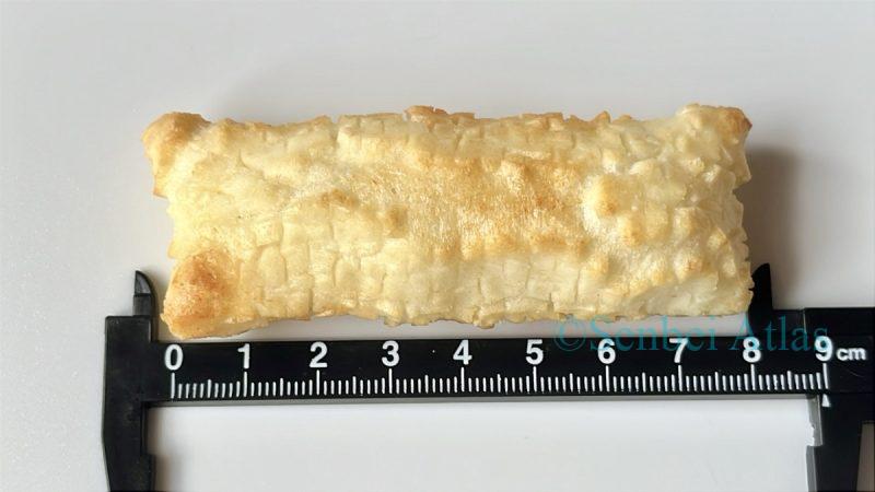 Measuring the size of an Inaka no Okaki (田舎のおかき) rice cracker with a ruler.